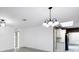 Open dining area featuring modern light fixtures, freshly painted walls, and updated floors at 7490 Locust Ne St, St Petersburg, FL 33702