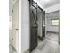 Hallway featuring sliding barn doors, adding a touch of rustic charm to the clean, modern space at 7490 Locust Ne St, St Petersburg, FL 33702