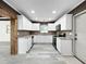 Bright kitchen with white cabinets, stainless appliances, granite countertops, and a decorative backsplash at 7490 Locust Ne St, St Petersburg, FL 33702