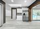 A stainless steel refrigerator is adjacent to white cabinets and drawers in this updated kitchen at 7490 Locust Ne St, St Petersburg, FL 33702