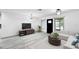 Bright living room features lots of natural light, modern furniture, and sleek flooring at 7490 Locust Ne St, St Petersburg, FL 33702