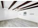 Modern living room with high ceilings, wood beams, a ceiling fan, and a small window at 7490 Locust Ne St, St Petersburg, FL 33702