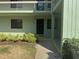 Exterior view of a building with a front door and manicured landscaping at 129 Caryl Way # 129, Oldsmar, FL 34677
