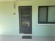 View of a front door with a 'welcome' mat and a window to the right at 129 Caryl Way # 129, Oldsmar, FL 34677