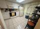 Functional kitchen with white cabinets, a microwave, and tile flooring at 129 Caryl Way # 129, Oldsmar, FL 34677