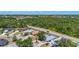 Aerial view of a neighborhood with mature trees and a road running through the community at 1369 Brookside Dr, Venice, FL 34285
