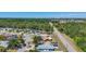 Aerial view of a neighborhood with mature trees and a road running through the community at 1369 Brookside Dr, Venice, FL 34285