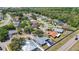 Aerial view of a neighborhood with houses, trees, and a road running through the community at 1369 Brookside Dr, Venice, FL 34285