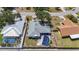 Aerial view of a residential home with a pool, grass, and fence at 1369 Brookside Dr, Venice, FL 34285