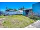 Backyard with some grass and a shed, all surrounded by a concrete fence at 1369 Brookside Dr, Venice, FL 34285