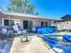 Backyard featuring a covered patio and in-ground pool covered in a blue tarp at 1369 Brookside Dr, Venice, FL 34285