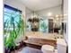 Bathroom with a bathtub, toilet, large mirror, and tropical plants at 1369 Brookside Dr, Venice, FL 34285