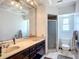 Bathroom with double vanity, mirror, and a walk-in shower at 1369 Brookside Dr, Venice, FL 34285
