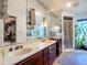 Bathroom with dual sinks, a large mirror, a shower, and a walk-in closet at 1369 Brookside Dr, Venice, FL 34285
