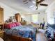 View of the bedroom features wood furnishings, overhead fan, and window with curtain at 1369 Brookside Dr, Venice, FL 34285