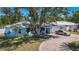 Charming single-story home with a well-maintained lawn, mature trees, and spacious driveway at 1369 Brookside Dr, Venice, FL 34285