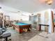 Spacious living room with a pool table, and plenty of space for entertaining guests at 1369 Brookside Dr, Venice, FL 34285