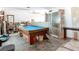 Spacious living room with a pool table, and plenty of space for entertaining guests at 1369 Brookside Dr, Venice, FL 34285