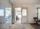 View of the living room showing entrance to a covered porch and access to an adjacent room at 1369 Brookside Dr, Venice, FL 34285