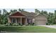 Charming single-story home with stone accents, a two-car garage, and a well-manicured lawn at 2185 Sulstone Dr, Punta Gorda, FL 33983