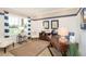 Stylish home office with a large window, nautical decor, and a dark wood desk at 2185 Sulstone Dr, Punta Gorda, FL 33983