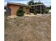Charming backyard with lush landscaping, rock beds, and a screened-in lanai at 22227 Elmira Blvd, Port Charlotte, FL 33952