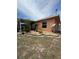 Beautifully landscaped backyard with tropical plants, rock beds, and a screened-in patio at 22227 Elmira Blvd, Port Charlotte, FL 33952