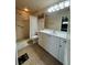 Well-lit bathroom featuring a walk-in shower and a vanity with ample storage space at 22227 Elmira Blvd, Port Charlotte, FL 33952