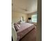 Well-lit bedroom with a large bed, dresser, and window offers a cozy and inviting space at 22227 Elmira Blvd, Port Charlotte, FL 33952