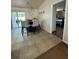 Dining area with table and chairs, tile floor and access to the patio and bedroom at 22227 Elmira Blvd, Port Charlotte, FL 33952
