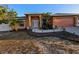 Charming single-story home with a well-maintained lawn and an attached two-car garage at 22227 Elmira Blvd, Port Charlotte, FL 33952
