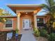 Inviting front entrance with charming welcome decor and manicured landscaping at 22227 Elmira Blvd, Port Charlotte, FL 33952
