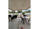 Screened patio area, featuring an outdoor grill and dining set, perfect for entertaining at 22227 Elmira Blvd, Port Charlotte, FL 33952