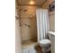 Detailed view of a tiled walk-in shower with a grab bar and rainfall showerhead at 22227 Elmira Blvd, Port Charlotte, FL 33952