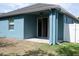 Covered back patio with sliding glass doors to yard and fan at 32618 Rapids Loop, Wesley Chapel, FL 33545