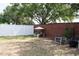 Fenced backyard with seating area and mature trees provides a private and inviting outdoor space at 32618 Rapids Loop, Wesley Chapel, FL 33545