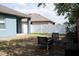 Spacious backyard with outdoor seating area provides a relaxing space, complemented by a privacy fence at 32618 Rapids Loop, Wesley Chapel, FL 33545