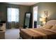Serene bedroom features a decorative mirror, plush carpet, and large window enhancing the natural light at 32618 Rapids Loop, Wesley Chapel, FL 33545