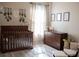 Cozy Bedroom with dark wood crib and dresser, soft rug, and natural light at 32618 Rapids Loop, Wesley Chapel, FL 33545