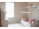 Charming bedroom with unique house frame bed, natural light, and neutral tones for a calming space at 32618 Rapids Loop, Wesley Chapel, FL 33545
