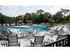 Resort-style community pool with ample seating, lounge chairs, and umbrella-shaded tables at 32618 Rapids Loop, Wesley Chapel, FL 33545