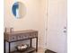 Welcoming entryway features stylish console table, mirror, and front door at 32618 Rapids Loop, Wesley Chapel, FL 33545