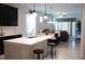 Modern kitchen with sleek black cabinets, a large island, and open dining area at 32618 Rapids Loop, Wesley Chapel, FL 33545
