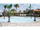 Community splash pad with palm tree water features, lounge chairs, and shaded seating areas at 32618 Rapids Loop, Wesley Chapel, FL 33545