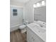 Bathroom featuring a tub/shower combo, toilet, and vanity with solid surface top at 38832 Henry Dr, Zephyrhills, FL 33542