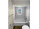 Bathroom featuring a white tub with tile surround and a window above at 38832 Henry Dr, Zephyrhills, FL 33542