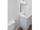 Bathroom vanity with white countertops, updated faucet, and tiled flooring at 38832 Henry Dr, Zephyrhills, FL 33542