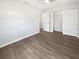 Bedroom featuring luxury vinyl plank flooring and a double door closet at 38832 Henry Dr, Zephyrhills, FL 33542