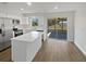 Modern kitchen with white cabinets, stainless steel appliances, a peninsula counter, and sliding doors to screened patio at 38832 Henry Dr, Zephyrhills, FL 33542