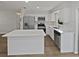 Open concept kitchen with stainless steel appliances, white cabinets, quartz countertops and island, and recessed lighting at 38832 Henry Dr, Zephyrhills, FL 33542